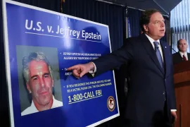 US Attorney Geoffrey Berman points to a photograph of Jeffrey Epstein as he announces charges against the financier of sex trafficking of minors and conspiracy in 2019 [File: Shannon Stapleton/Reuters]