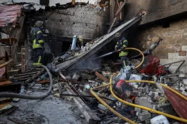 Rescuers work at a site of Russian military strike, in Kherson, Ukraine [Oleksandr Ratushniak/Reuters]