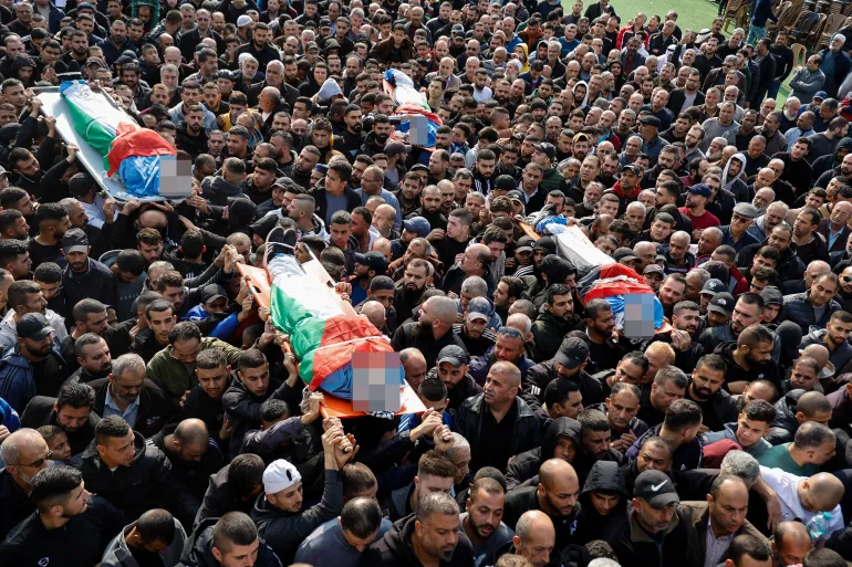 People carry the bodies during the funeral of Palestinians who were killed in an Israeli drone strike, in Tulkarm, in the Israeli-occupied West Bank
