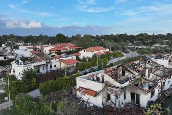 Charred and damaged houses are seen from above.