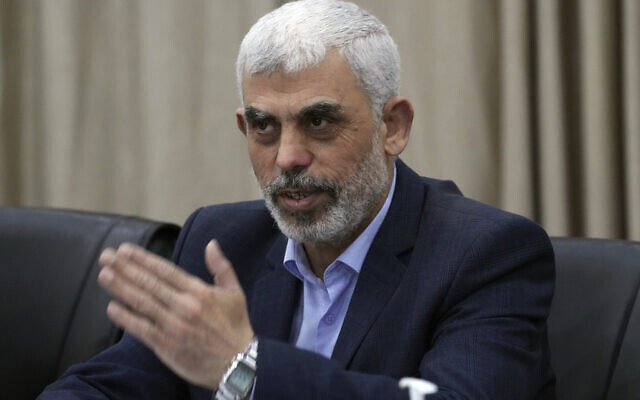 Yahya Sinwar, head of Hamas in Gaza, greets his supporters during a meeting with leaders of Palestinian factions at his office in Gaza City, April 13, 2022. (AP Photo/Adel Hana, File)