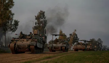 A convoy of Israeli army armoured personnel carriers (APC) moves near the Israeli-Gaza border, in southern Israel, on Monday.