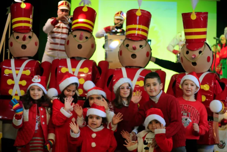 Lebanese kids celebrate a Christmas party, at Saint-Joseph des Saints-Coeurs School in Ain Ebel, a Lebanese Christian border village with Israel, in south Lebanon, on Saturday, Dec. 23, 2023. Christians in the border villages of south Lebanon prepared for a subdued Christmas under the shadow of the ongoing war in Gaza and its spillover in Lebanon. (AP Photo/Mohammed Zaatari)