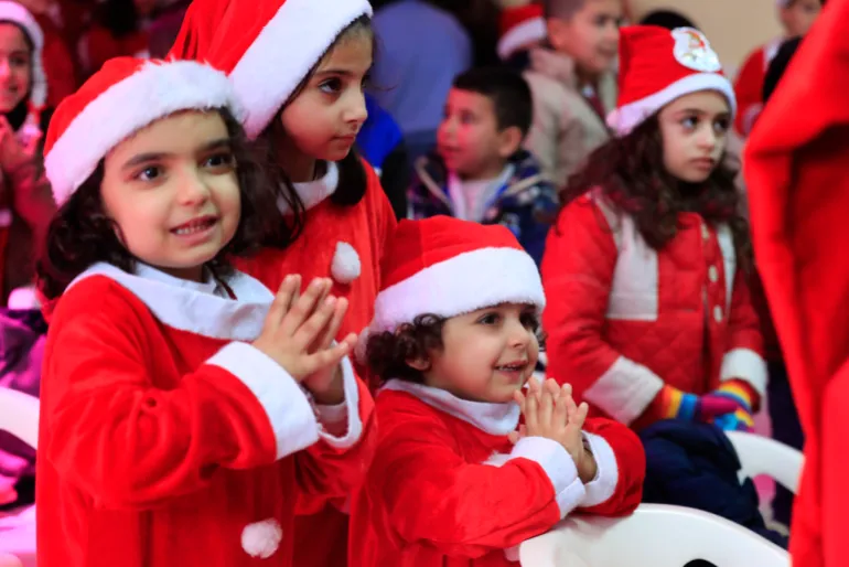 Lebanese children celebrate a Christmas party, at Saint-Joseph des Saints-Coeurs School in Ain Ebel, a Lebanese Christian border village with Israel, in south Lebanon, on Saturday, Dec. 23, 2023. Christians in the border villages of south Lebanon prepared for a subdued Christmas under the shadow of the ongoing war in Gaza and its spillover in Lebanon. (AP Photo/Mohammed Zaatari)
