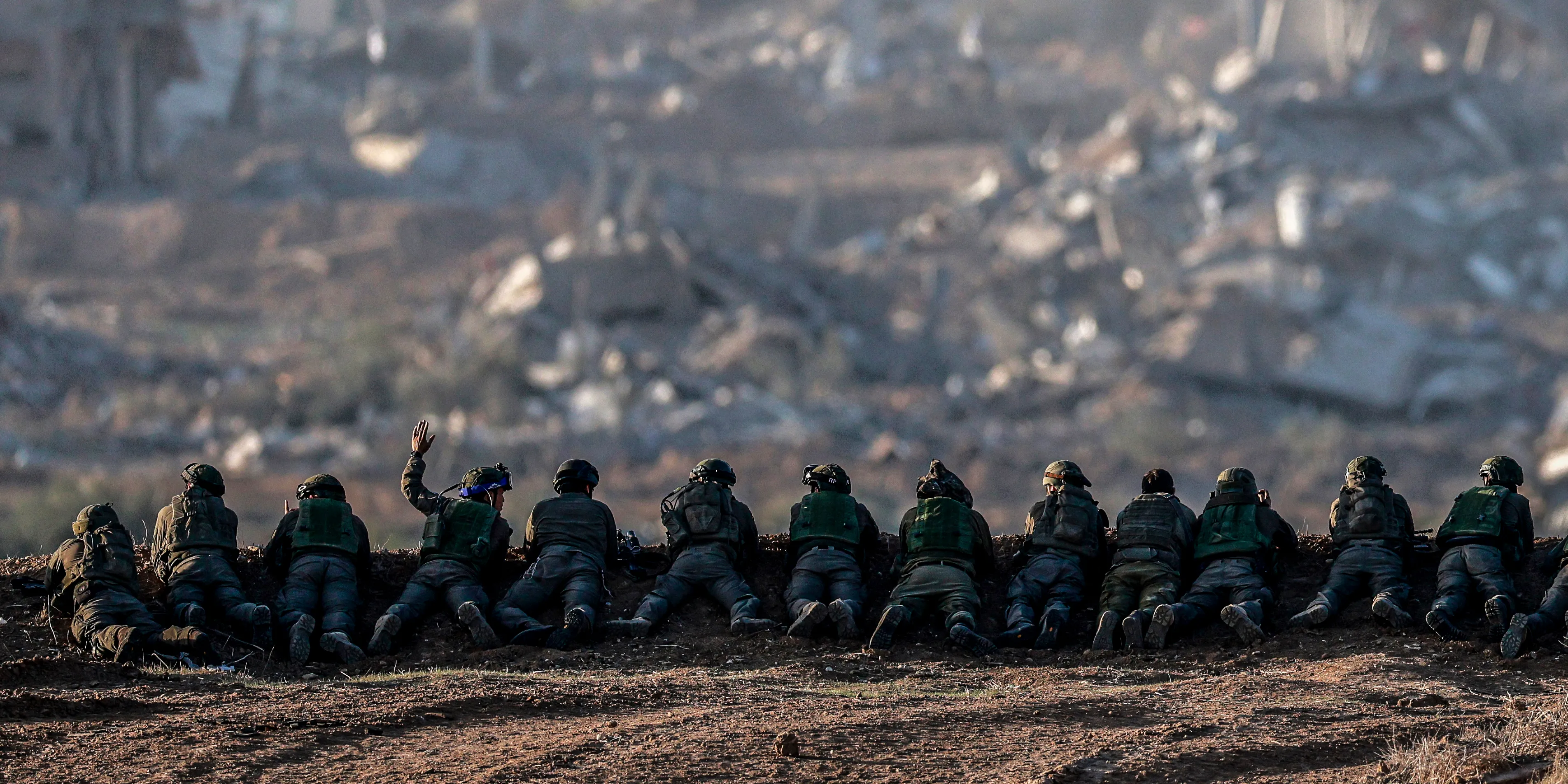 TOPSHOT - A picture taken in southern Israel near the border with the Gaza Strip on December 11, 2023, shows Israeli army soldiers keeping position on a hill overlooking northern Gaza, amid continuing battles between Israel and the militant group Hamas. (Photo by Menahem KAHANA / AFP) (Photo by MENAHEM KAHANA/AFP via Getty Images)