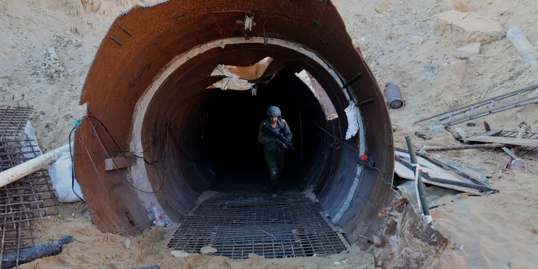 TOPSHOT - In this picture taken during a media tour organized by the Israeli military on December 15, 2023, an Israeli soldier exits a tunnel that Hamas reportedly used to attack Israel through the Erez border crossing on October 7. The Israeli army said on December 17, 2023 it had uncovered the biggest Hamas tunnel in the Gaza Strip so far, just a few hundred meters from the Erez border crossing. (Photo by JACK GUEZ / AFP) (Photo by JACK GUEZ/AFP via Getty Images)