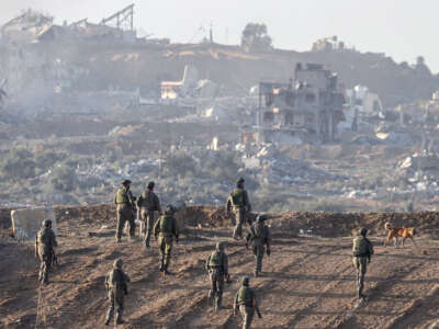 A picture taken in southern Israel near the border with the Gaza Strip on December 11, 2023, shows Israeli army soldiers taking position on a hill overlooking northern Gaza.
