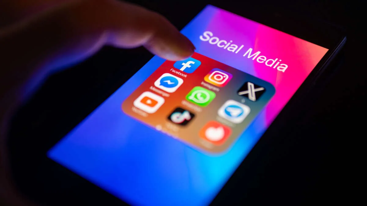 A close-up of a finger is pointing to the Facebook mobile app on a smartphone screen, which is displayed alongside other apps including Instagram, WhatsApp, Telegram, TikTok, Tinder, YouTube, and Messenger, on November 30, 2023.