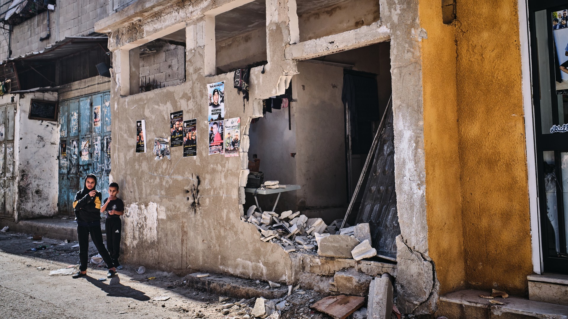 Children stand next to a home destroyed during an Israel army raid in the Balata refugee camp in the occupied West Bank (MEE/Angelo Calianno)
