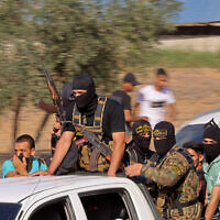 Palestinian terrorists head toward the border with Israel from Khan Yunis in the southern Gaza Strip on October 7, 2023. (SAID KHATIB / AFP)