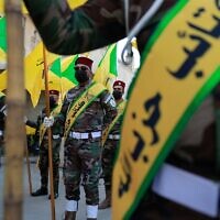 Members of the Hezbollah brigades, Kataeb Hezbollah, attend the funeral of Fadel al-Maksusi, a fighter who was also part of the Islamic Resistance in Iraq, the group that has claimed all recent attacks against US troops in Iraq and Syria, in Baghdad on November 21, 2023. (AHMAD AL-RUBAYE / AFP)