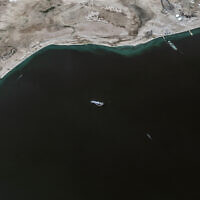 This handout satellite picture released by Maxar Technologies on November 28, 2023, shows the recently seized Israeli-linked Galaxy Leader ship (C), that was captured by Houthi rebels on November 19, next to a support vessel in the southern Red Sea near Hodeida, Yemen. (Photo by Satellite image ©2023 Maxar Technologies / AFP)