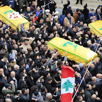 Mourners carry the coffins of a Hezbollah fighter and two other people who killed by an Israeli airstrike that hit their house in Bint Jbeil, South Lebanon, December 27, 2023. (Mohammed Zaatari/AP)