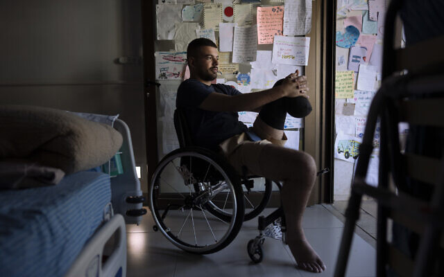 IDF soldier Jonathan Ben Hamou, 22, wounded in the war with Hamas, in his room at Sheba hospital's rehabilitation division, in Ramat Gan, December 18, 2023. (AP Photo/Oded Balilty)