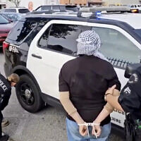 This video still image provided by KABC-TV shows protesters being arrested by Los Angeles police officers on Wednesday, Dec. 27, 2023, near Los Angeles International Airport. Pro-Palestinian, anti-Israel protesters briefly blocked entrance roads to airports in New York and Los Angeles, forcing some travelers to set off on foot to bypass the jammed roadway. (KABC-TV via AP)