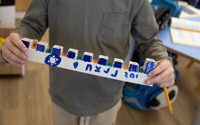 Children from evacuated communities in the Gaza envelope and the north of Israel make menorahs to send to IDF soldiers fighting Hamas in the Gaza Strip (IDF)