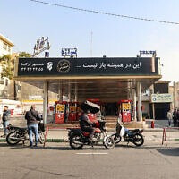 People wait at a gas station in Tehran on December 18, 2023, as fuel distribution across 70 percent of Iran's gas stations was disrupted due to a 'possible sabotage, state media reported. (ATTA KENARE / AFP)