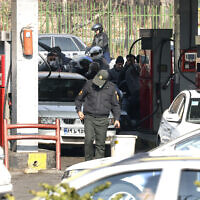 People wait at a gas station in Tehran on December 18, 2023 as fuel distribution across 60 percent of Iran's gas stations is disrupted in an alleged Israel-linked cyberattack. (Photo by ATTA KENARE / AFP)