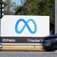 A car passes Facebook's new Meta logo on a sign at the company headquarters in Menlo Park, California, on October 28, 2021. (Tony Avelar/AP)