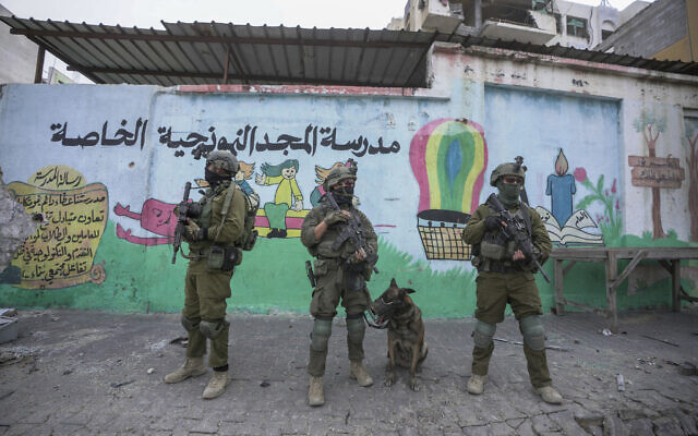 Israeli soldiers are seen during a ground operation in the Gaza Strip, Wednesday, Nov. 22, 2023. (AP Photo/Victor R. Caivano)