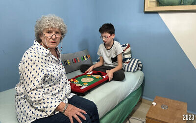 The Munders from Kibbutz Nir Oz -- grandfather Avraham Munder is still held captive in Gaza, represented by the empty seat, while his grandson, Ohad and wife Ruti, were released after 49 days in captivity after the family was taken hostage on October 7, 2023 (Courtesy)