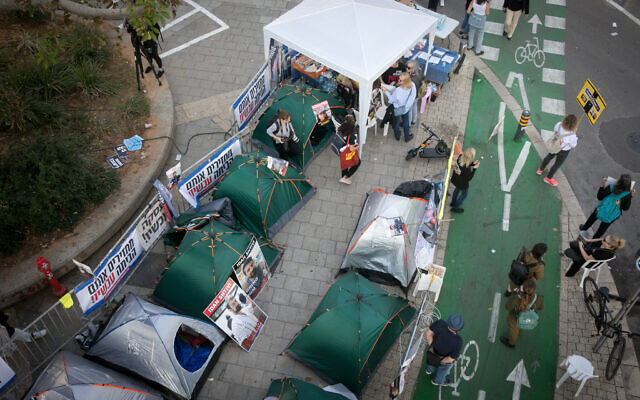 Families of Israelis held hostage by Hamas terrorists in Gaza have formed a tent city outside Tel Aviv's Hakirya Base, December 18, 2023. (Miriam Alster/Flash90)
