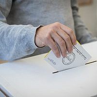 Illustrative: A man casts his ballot at a voting station in Israel's municipal elections, October 30, 2018, in Jerusalem. (Yonatan Sindel/Flash90)