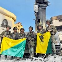 Troops of the Golani Brigade's 13th Battalion stand by a Hamas monument at the Palestine Square in Gaza City's Shejaiya neighborhood, December 18, 2023. (Israel Defense Forces)