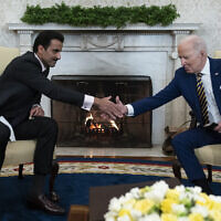 US President Joe Biden, right, shakes hands with Qatar's Emir Sheikh Tamim bin Hamad Al Thani in the Oval Office of the White House, January 31, 2022, in Washington. (AP Photo/Alex Brandon)