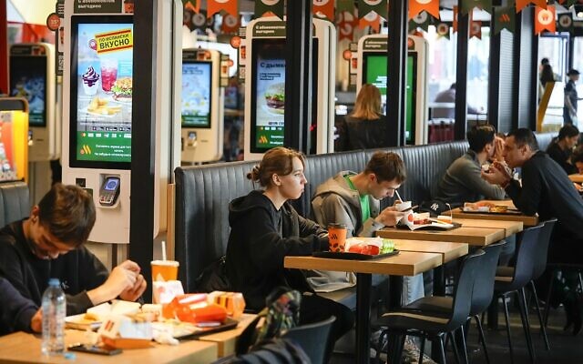 People eat at a fast food restaurant, Vkusno-i Tochka, in a former McDonald's outlet in Bolshaya Bronnaya Street in Moscow, Russia, June 5, 2023. (AP Photo/Alexander Zemlianichenko)