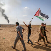 Smoke billows at the border fence with Israel from Khan Younis in the southern Gaza Strip after some 3,000 Hamas terrorists stormed the border and entered Israel, October 7, 2023. (Abed Rahim Khatib/Flash90)