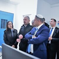 National Security Minister Itamar Ben Gvir (center) listens to Israel Prison Service chief Katy Perry (left) during a visit to Nafha Prison, January 6, 2023. (Israel Prison Service)