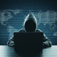 Illustrative: Hacker using laptop on abstract binary code map background. (Peshkov/ iStock, by Getty Images)