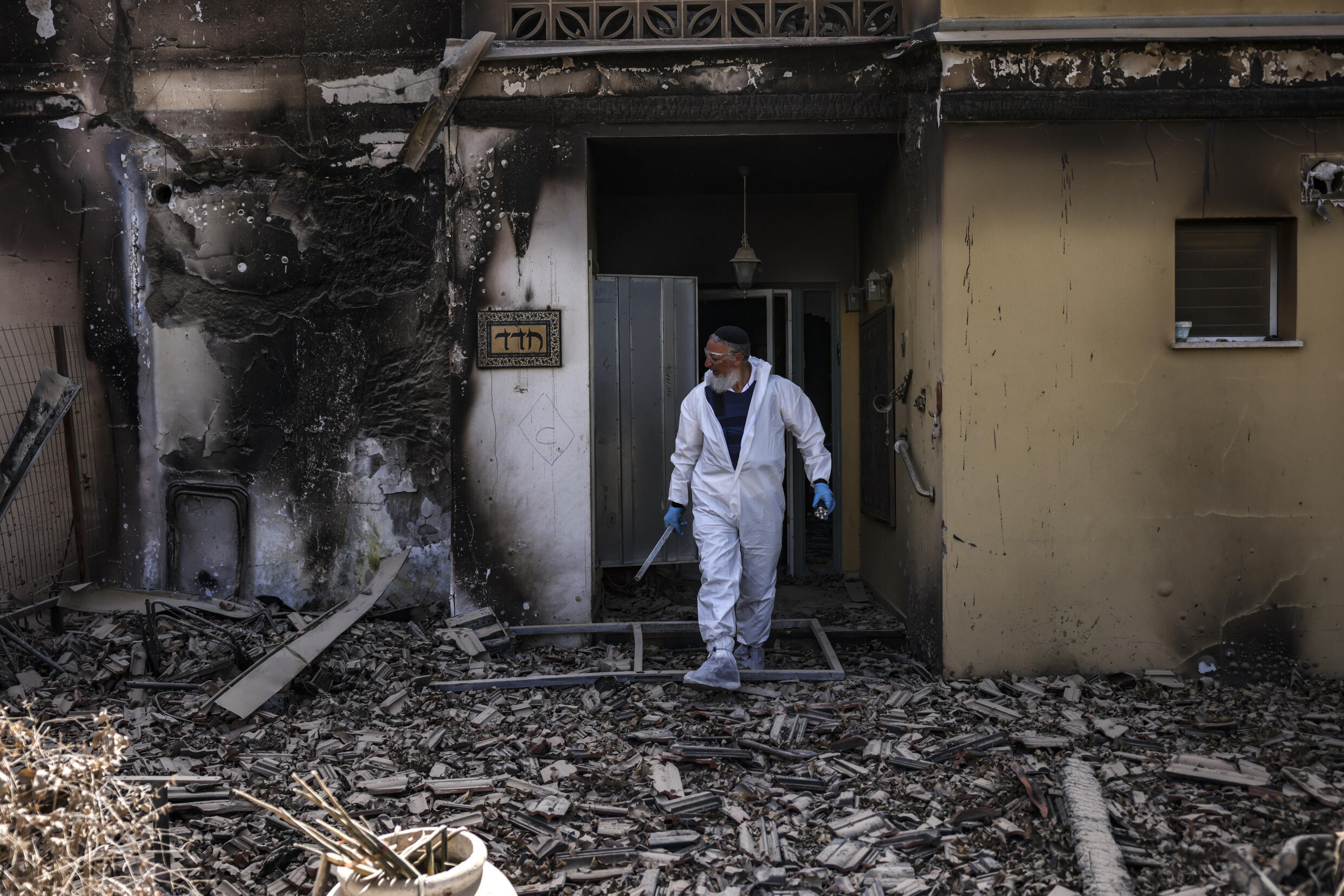 A Zaka NGO volunteer amid the debris in Kibbutz Beeri