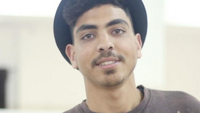 Young man in a hat smiling