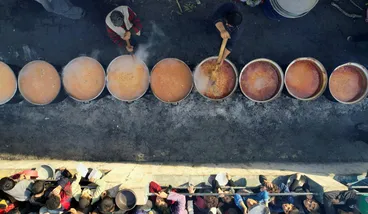 Palestinians gather to receive food cooked by a charity kitchen, in Rafah in the southern Gaza Strip, on Sunday.