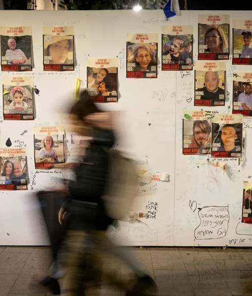 A wall of posters featuring hostages held by Hamas near the Tel Aviv Museum of Art.